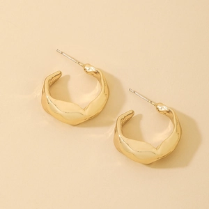 Detailed macro view of irregular molten texture on gold plated hoop earrings
