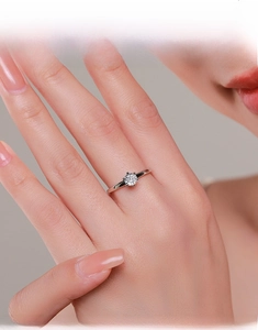 Close-up of a 925 sterling silver six-prong solitaire ring worn on a finger
