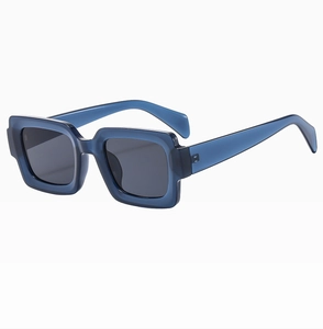 Detail view of deep blue square frame sunglasses with thick temples and gray lenses