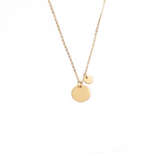 Macro detail of high-polish gold double round disc pendants on minimalist O-chain necklace