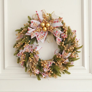 50cm Christmas wreath with gingerbread bow and golden ornaments hanging on a white door