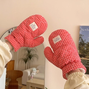 Detail of red checkered quilted gloves with soft white faux shearling lining for warmth