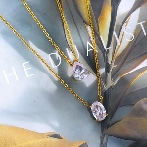 Detail of 18K gold plated double layer necklace with pear and oval cubic zirconia pendants