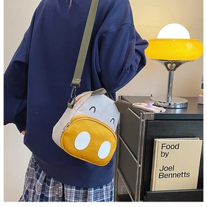 Detail view of the yellow cartoon animal backpack with adjustable shoulder strap