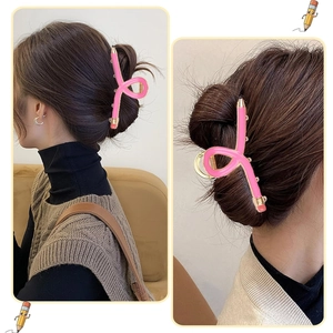 Macro detail of a creative pink pencil hair claw clip used in a stylish hair bun