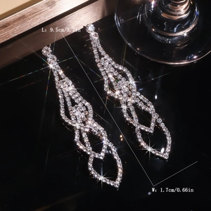 Detailed size view of silver rhinestone tassel earrings measuring 9.5cm in length