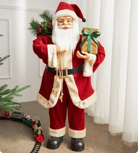 Detail of Santa Claus figure with velvet suit holding a gold gift box and festive bag