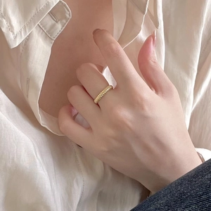 Polished gold twisted rope ring for women shown on hand for a minimalist fashion look