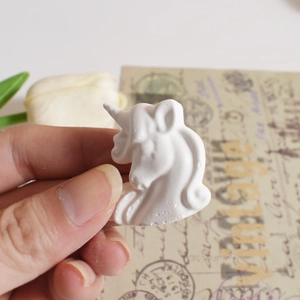 Macro detail of a white unicorn resin mold head for DIY jewelry and keychain pendants