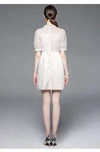 Detail of elegant lace stitching and beaded luxury dress in soft pink for women