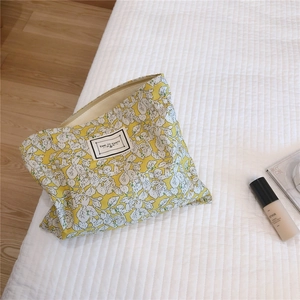 Floral cotton makeup bag with metal zipper and Time To Party patch on quilted fabric