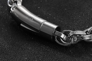 Macro shot of silver stainless steel chain bracelet showing vintage clasp and link detail