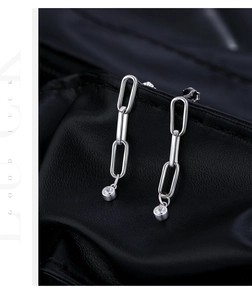 Macro view of S925 silver long chain earrings with dangling round white zircons