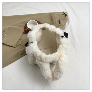 Detail view of plush tote bag interior with magnetic clasp and fuzzy white texture