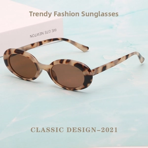 Classic 2021 design oval tortoiseshell sunglasses with brown lenses on blue water background