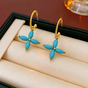Elegant gold plated clover flower drop earrings with green stones and twisted hooks