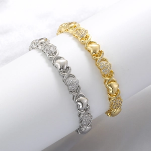 Elegant gold and silver heart link bracelets with sparkling crystals on a white display