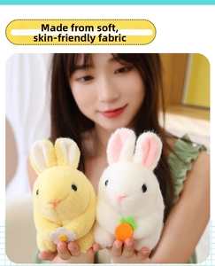 Close-up of soft plush rabbit toys held in hand featuring cute carrot and flower details