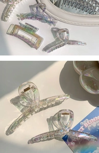 Macro detail of iridescent laser large shark hair clips with rainbow finish