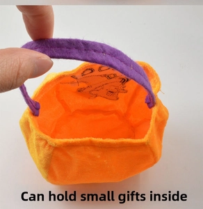 Macro view of orange velvet pumpkin bag with purple handle for Halloween treats and candy