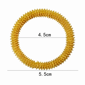 Detail showing 4.5cm and 5.5cm dimensions of a golden metallic spring massage wrist ring