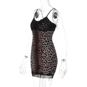Close-up of leopard print fabric featuring delicate black lace trim on the neckline and hem