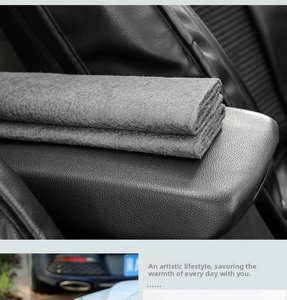 Macro detail showing thick grey felt texture and soft material of the car armrest mat