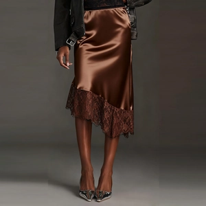 Detailed view of brown satin midi skirt featuring delicate lace patchwork and asymmetric hem