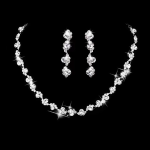 Close-up of sparkling silver bridal jewelry set with crystal necklace and earrings