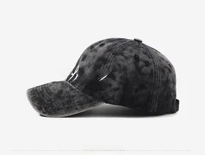 Close-up of vintage dark grey washed baseball cap with white 3D letter embroidery details