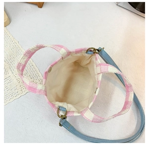 Detail view of pink plaid canvas bag interior showing cotton lining and magnetic closure