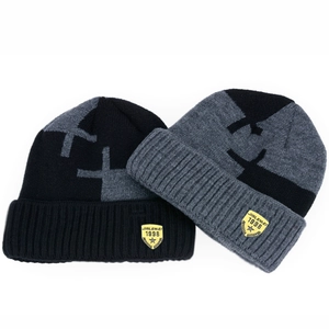 Detail of winter knitted beanie with brand logo patch and thick ribbed texture