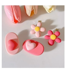 Close-up of pink and yellow floral and heart hair clips set with 4 pieces for girls