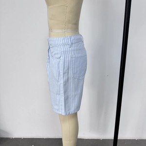 Detail of high waisted striped denim shorts showing blue vertical stripes and side pocket