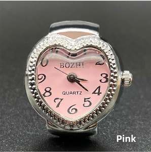 Detail of pink heart-shaped dial ring watch with silver alloy case and quartz movement