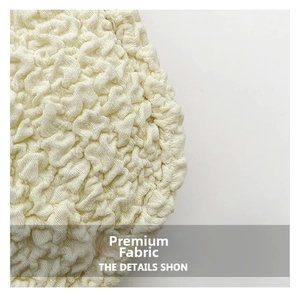 Close-up of off-white popcorn texture knit fabric on a large cloud crossbody bag