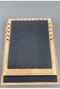 Detail view of wooden jewelry display tray with grey microfiber lining and necklace notches