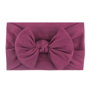 Soft nylon baby headband with large bow in burgundy red for toddlers and infants