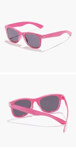 Detail view of pink glitter kids square sunglasses with folded temple and front frame