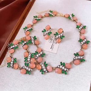 Vintage Baroque jewelry set featuring pink resin stones and green marquise crystals