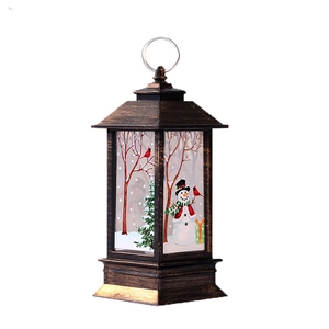 Vintage bronze Christmas lantern with snowman snow scene and hanging ring on white background