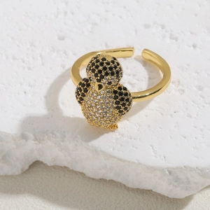 Macro detail of penguin ring featuring black and clear cubic zirconia on 14K gold plated band