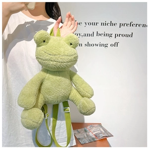 Green plush frog backpack with soft texture and adjustable straps shown on model back