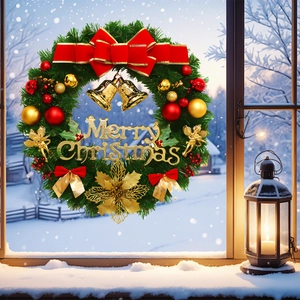 Christmas wreath detail with red bow, gold bells and Merry Christmas sign on snow window