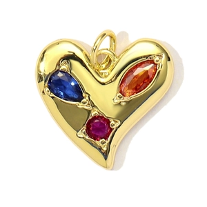 Macro shot of heart-shaped gold pendant featuring colorful inset cubic zirconia stones
