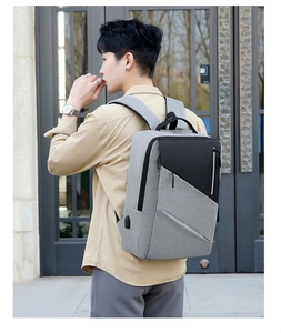 Detailed view of grey business backpack showing the integrated side USB charging port
