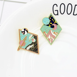 Cosmic wave and night mountain landscape enamel pins with golden rhombus frame