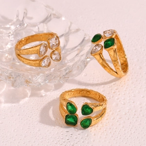 Detail of 18K gold plated hammered texture rings with green and clear zircon gemstones