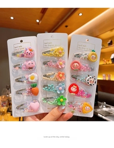 Detail of colorful fruit hair clips for girls with sequins and cute cartoon charms