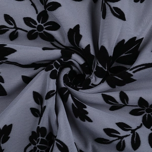 Detailed macro view of grey semi-transparent mesh fabric with black flocked floral patterns